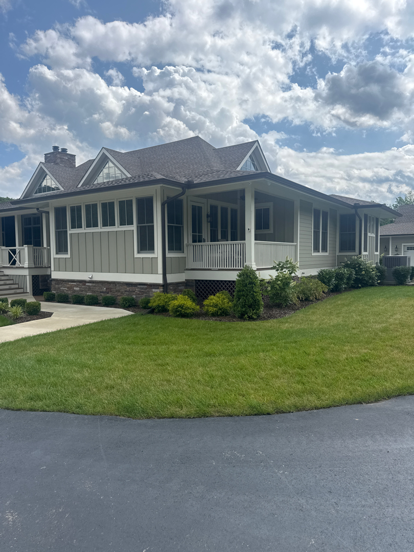 Professional residential project featuring large paved driveway and maintained lawn areas